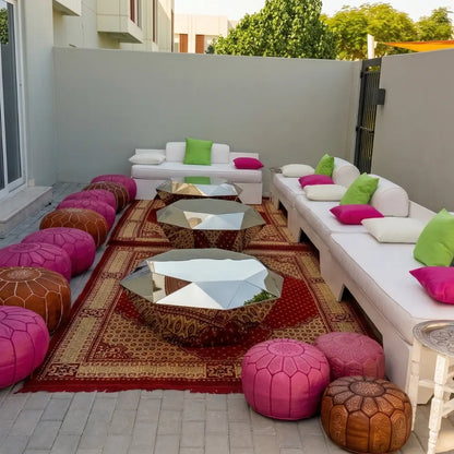 Rug Oriental Red enhances an outdoor lounge with rich hues, complemented by white sofas and mirror-polished tables, ideal for sophisticated events.