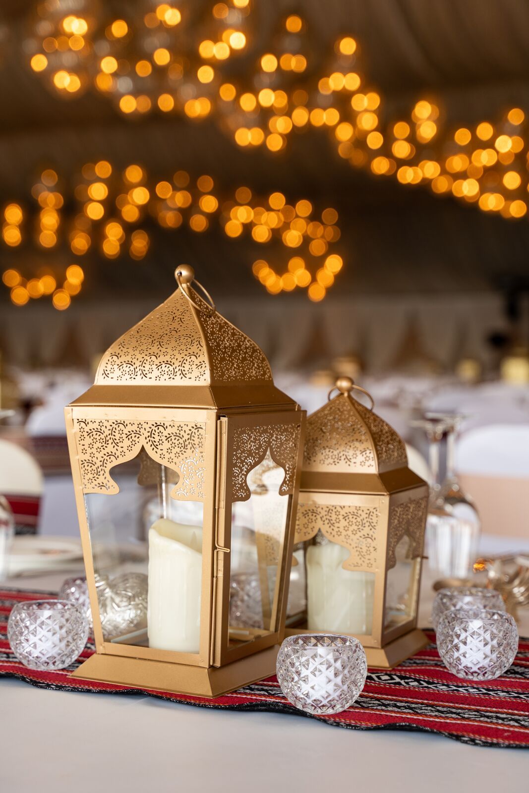 Rose Gold Lanterns displayed on a table, showcasing various sizes suitable for events. Candles are visible inside, illustrating potential decorative use.