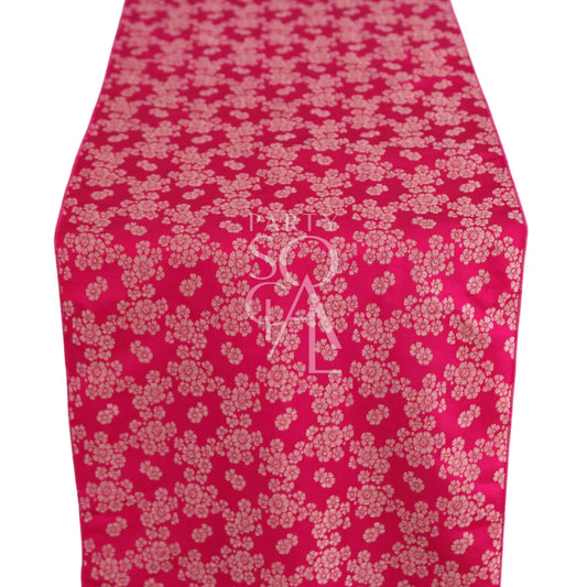 Brocade Table Runner featuring a red base with intricate white floral patterns, ideal for adding elegance to special event table settings.