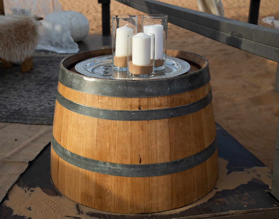 Rustic Half Wine Barrel Table with candles on top, ideal for event decor or as a unique table.