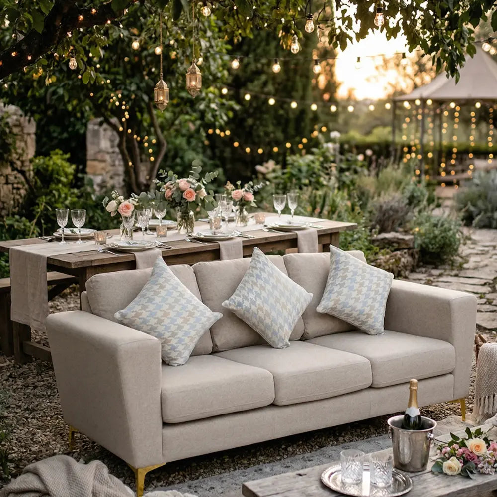 SAND FABRIC SOFA 3-SEATER set in a cozy outdoor garden, paired with a rustic dining table and ambient string lights, perfect for stylish event seating.