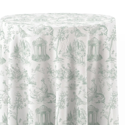 A round tablecloth with a classic French toile de Jouy pattern in sage green on an off-white background, showing draped fabric folds.
