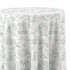 A round tablecloth with a classic French toile de Jouy pattern in sage green on an off-white background, showing draped fabric folds.