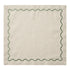 A square beige linen napkin with a scalloped green border, shown flat against a white background.