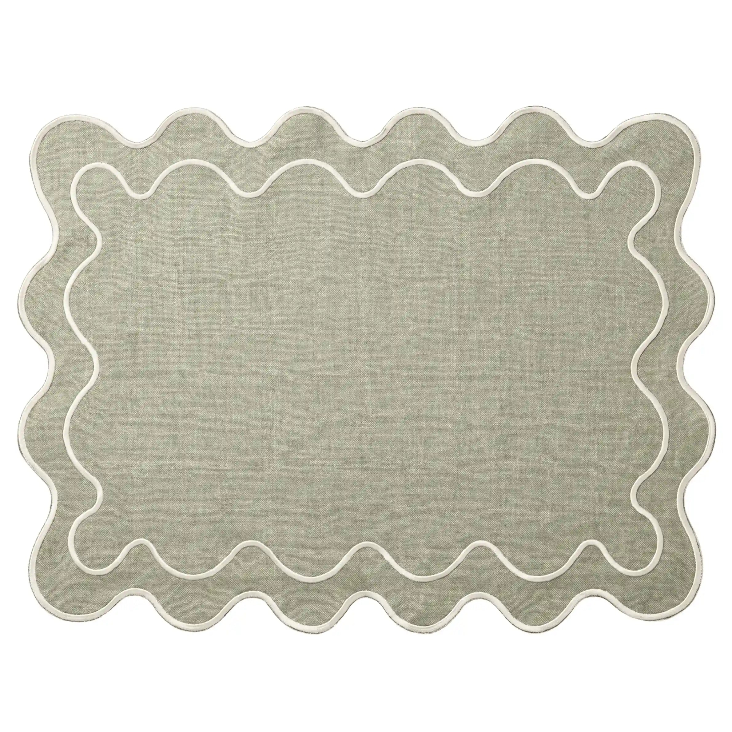 A rectangular area rug with a scalloped wavy border, shown flat against a solid white background. The rug features a textured sage green center with a thin white embroidered border.