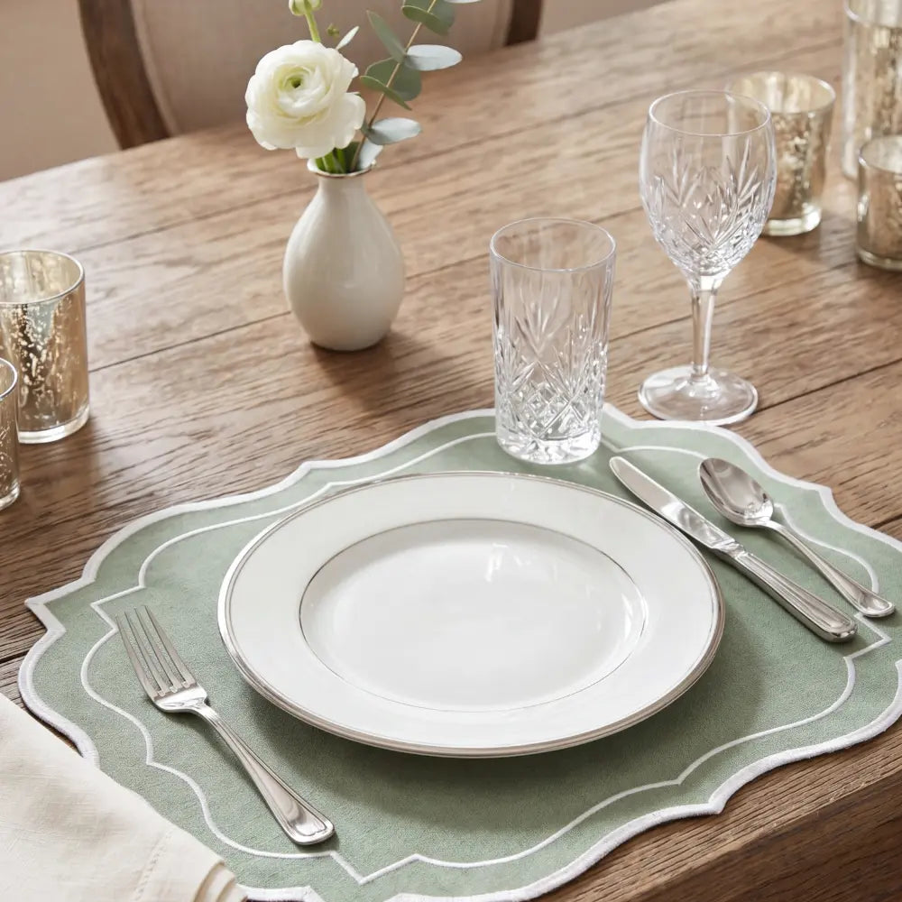 Sage Green Scalloped Linen Placemat with white-stitched border, showcasing elegant scalloped edges. Perfect for enhancing table settings, sold as a set of four.