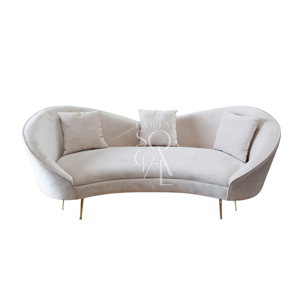 KOSHA SAND VELVET SOFA with modern design, featuring plush cushions and wooden tapered legs, ideal for stylish lounge seating, perfect for event spaces.