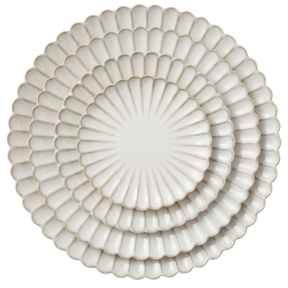 Scalloped Like Collection: Nesting set of three white ceramic plates with scalloped edges, showcasing a shell-like design perfect for elegant dining occasions.