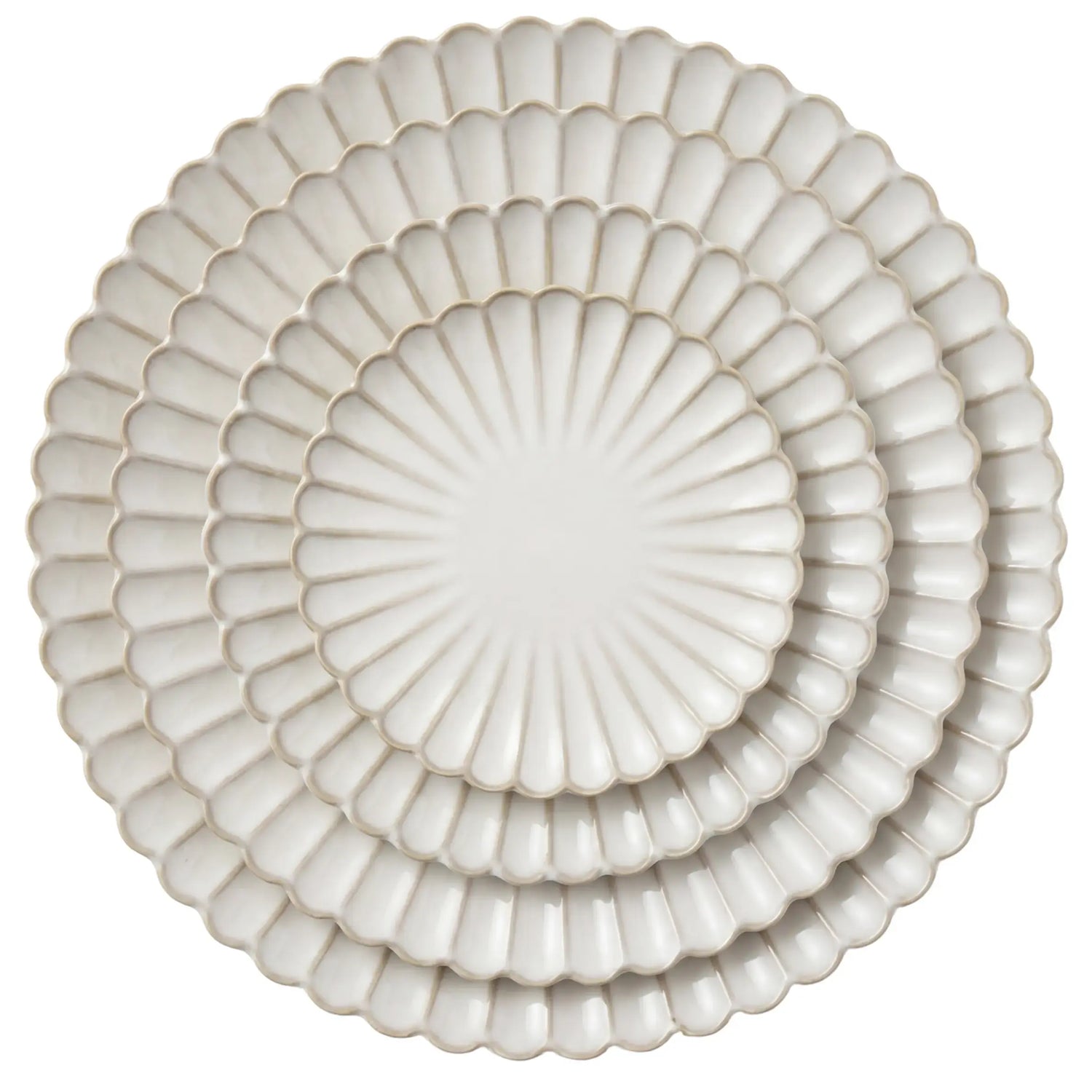 Scalloped Like Collection: Nesting set of three white ceramic plates with scalloped edges, showcasing a shell-like design perfect for elegant dining occasions.