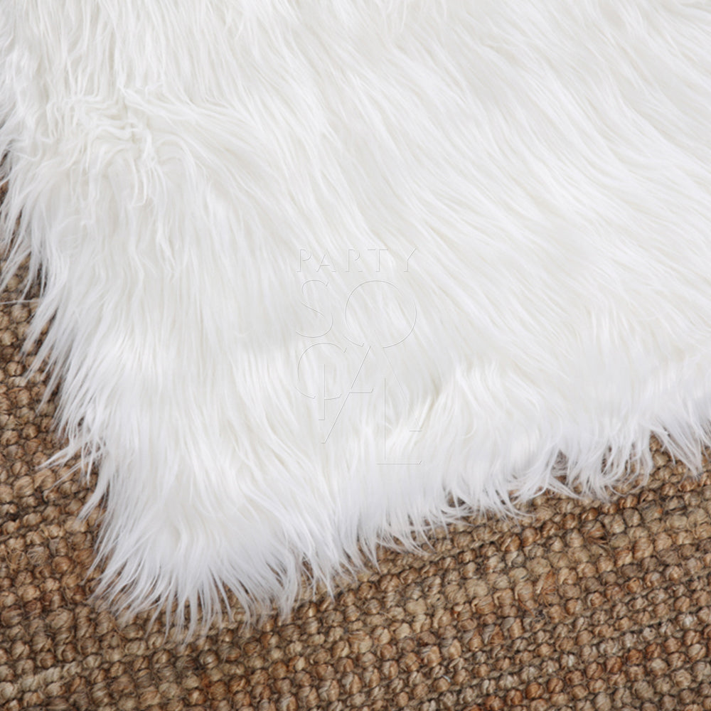 SHEEPSKIN RECTANGULAR rug on a brown surface, ideal for event decor or props, measuring 110cm by 70cm, showcasing its soft furry texture.