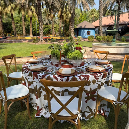uscan Terracotta Tablecloth. Featuring a bold botanical print in rich terracotta and earthy olive tones, this statement linen creates an effortlessly elevated setting inspired by Mediterranean dining.