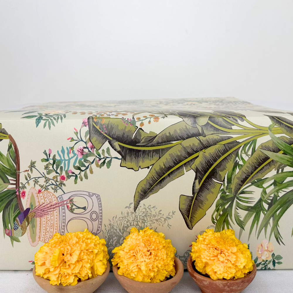 Diwali Thali Gift Box featuring yellow flowers in small bowls, perfect for special occasions and gift-giving.