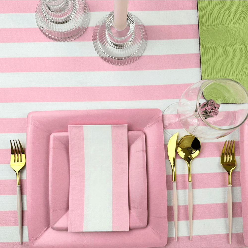 Bandol Stripe Paper Guest Towel Napkins - 15 Per Package, featuring pink and white striped table setting, pink plate with fork, and elegant tableware for eco-friendly style from Party Social.