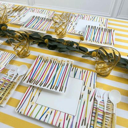 Paper plates and cutlery set on a table, featuring Caspari&