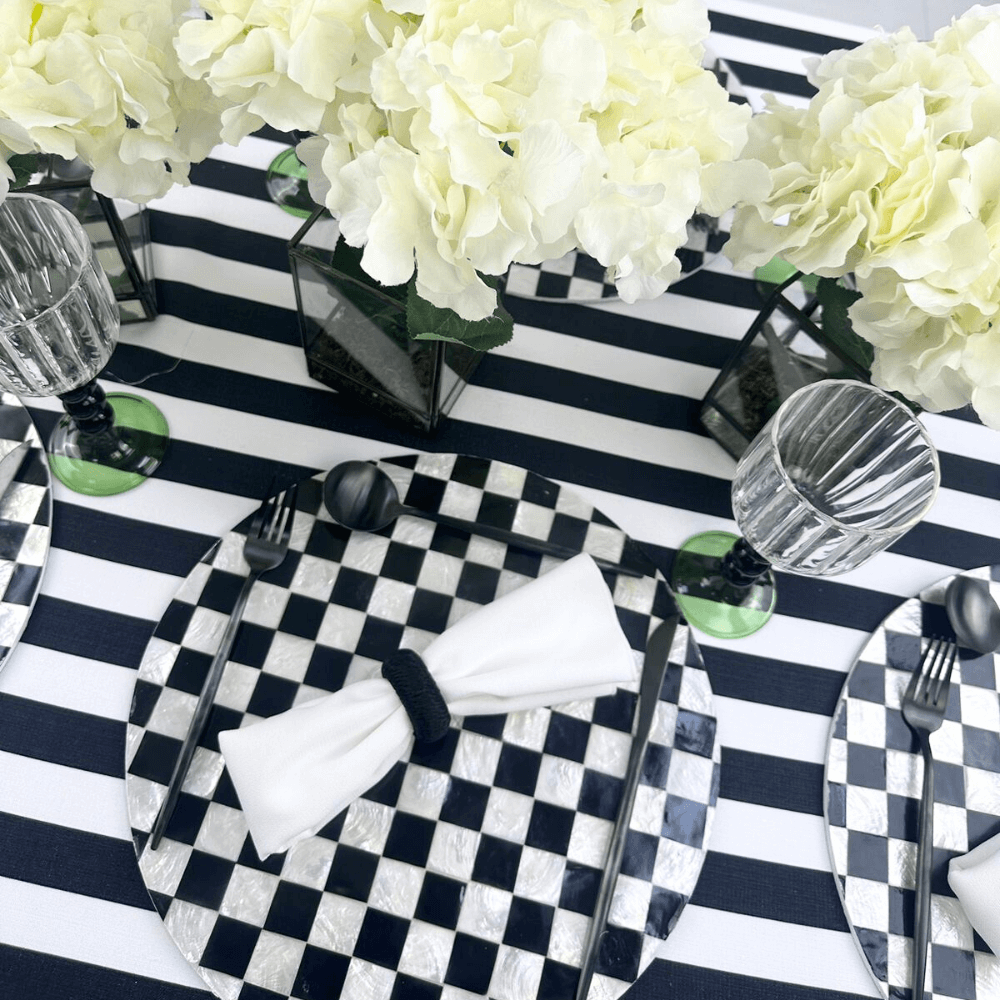 Rayon Napkin Ring- 6 per pack displayed on a black and white checkered plate with tableware and white flowers nearby.