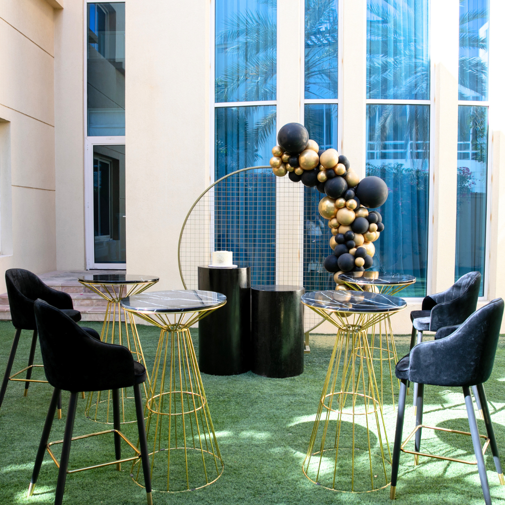 Black &amp; Gold Backdrop displayed at an outdoor event setup with black chairs and tables, showcasing a customizable theme for parties and special occasions.