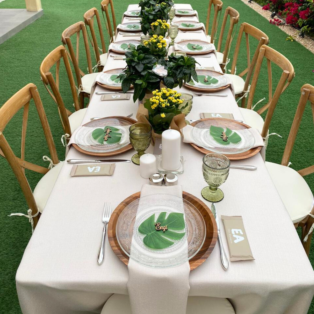 Rectangular linen blend tablecloth elegantly draped over a long table set with plates and flowers, ideal for special occasions.