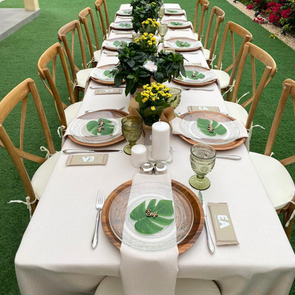 Rectangular linen blend tablecloth elegantly draped over a long table set with plates and flowers, ideal for special occasions.