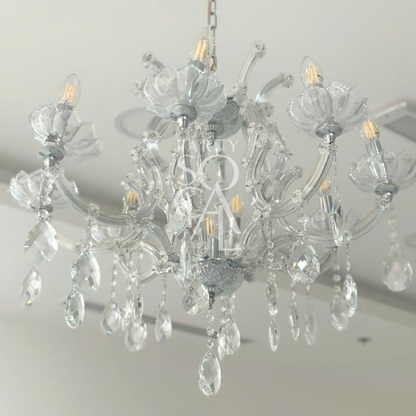 CRYSTAL CHANDELIER hanging elegantly, featuring intricate crystal glasswork, perfect for enhancing the ambiance of events and special occasions.