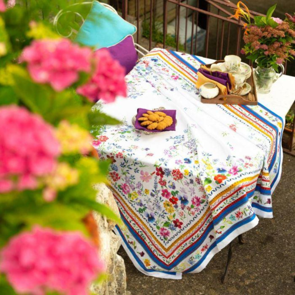 Vibrant Primrose Pure Linen Tablecloth on a table with a tray of cookies, enhancing a sophisticated dining setup.