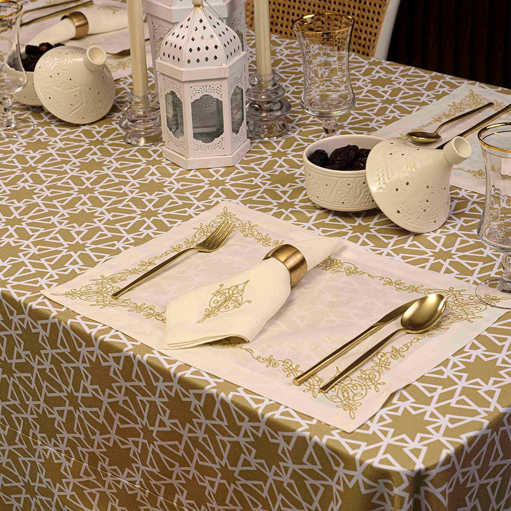 Geometric Linen Tablecloth-1 Each: Elegant table setting with gold and white geometric-patterned tablecloth, featuring utensils, a bowl of dried fruit, and decorative items.