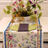 Vibrant Primrose Pure Linen Runner displayed on a table with flowers, candles, and a bowl of flowers, enhancing an elegant party setup.