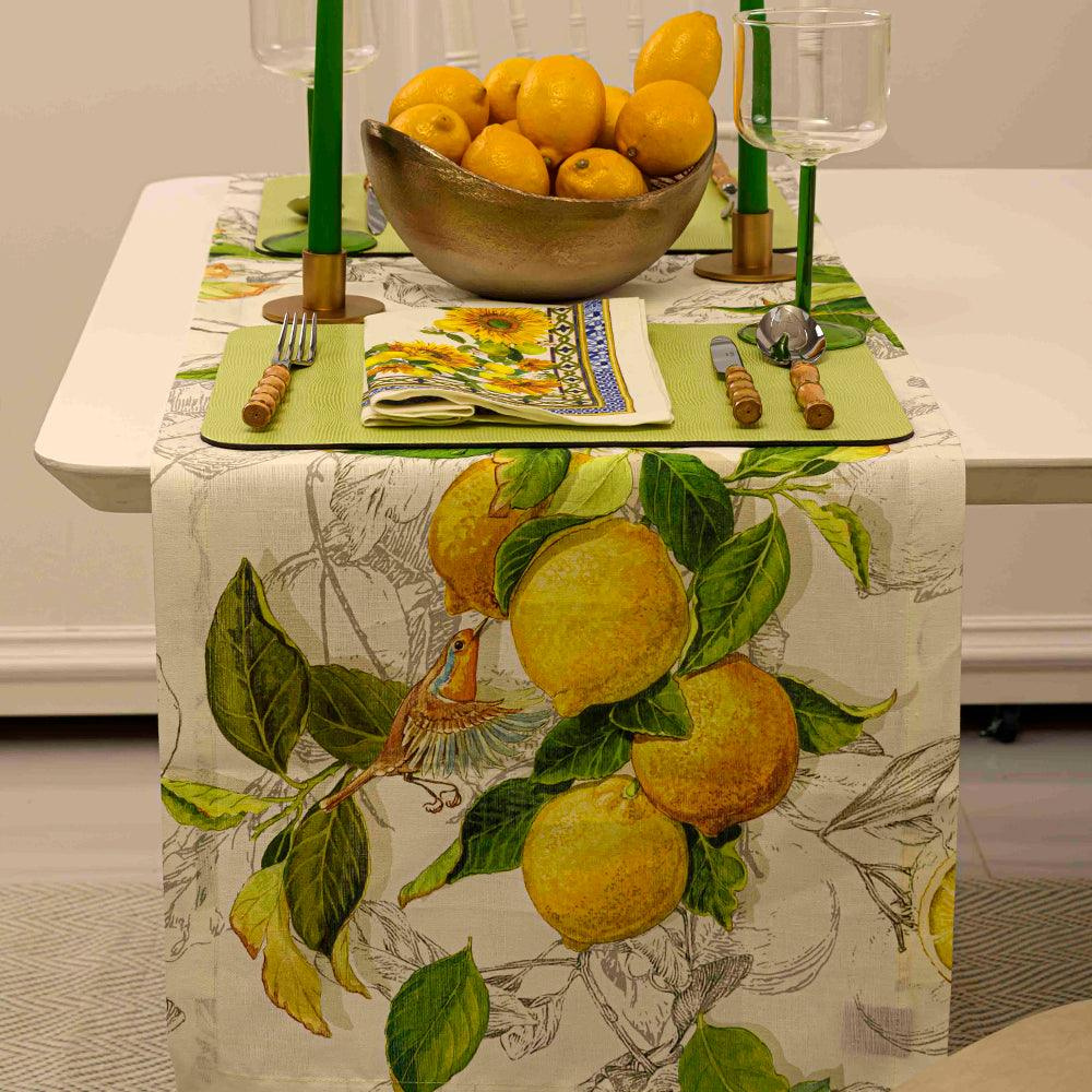 Limoncello Pure Linen Runner on a table with a bowl of lemons and candles, perfect for elegant dinner parties and events.