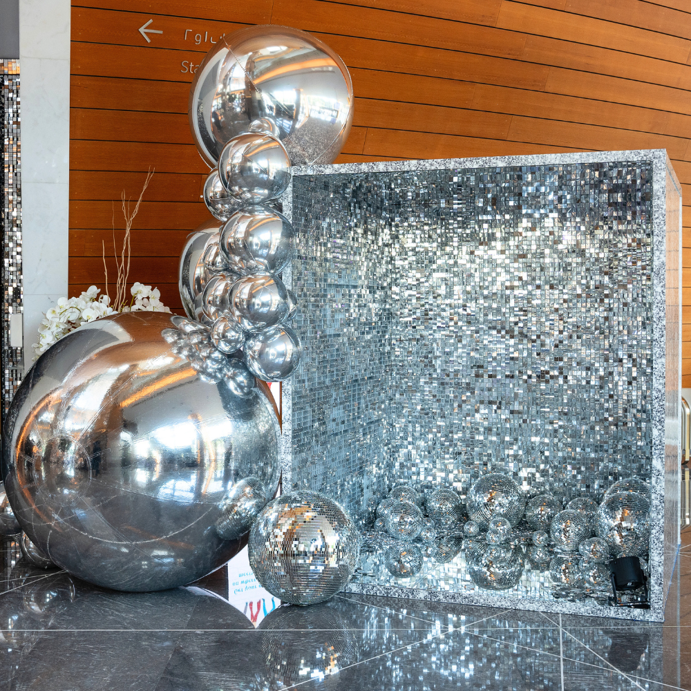 Silver mirror inflatable balls displayed; made from quality PVC, ideal for adding unique style to events. Available in various sizes for party decor.