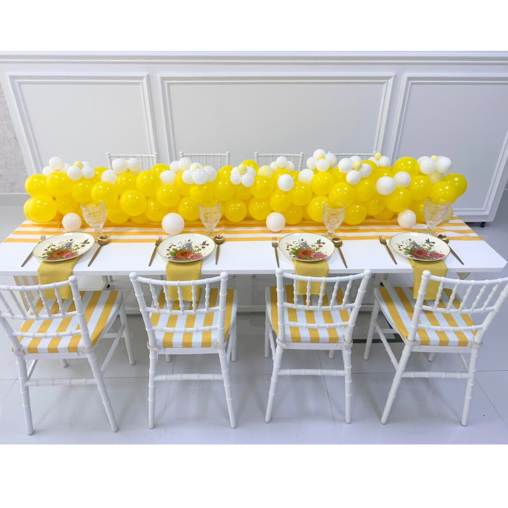 MINI CHIAVARI CHAIR WHITE arranged around a table with balloons, showcasing its stylish resin design, ideal for kids&