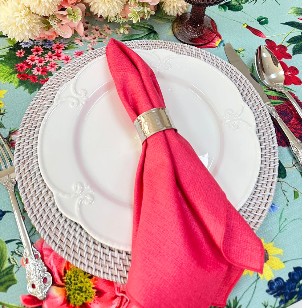 White Embossed Plates with floral design and napkin, ideal for luxury table settings, featuring a decorative silver ring, spoon, and flowers.