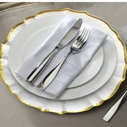 CHARGER PLATE - CLEAR PEARL W/ GOLD RIM, displayed with silverware, ideal for luxurious table settings at events.