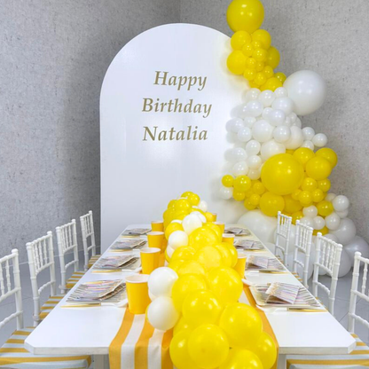 Simple Wood Curved Balloon Backdrop displayed on a table, adorned with yellow and white balloons, ideal for enhancing party decor at various events.