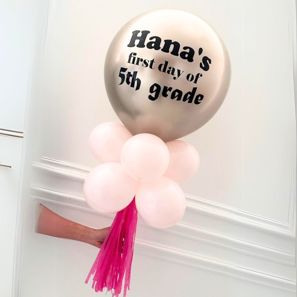 Personalised Back to School Balloon Wand - Metallic, featuring a large balloon with black text, surrounded by smaller pink and white balloons, and a matching tassel.