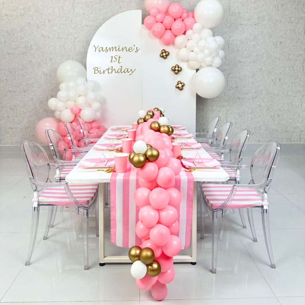 White rectangular table for kids with wooden top and steel legs, surrounded by pink and white balloons, ideal for party events.