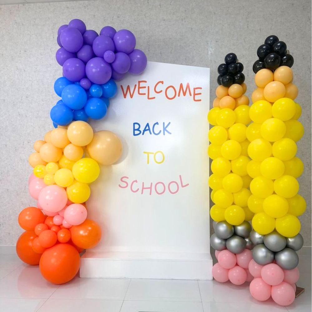 Angled Wall w/ Pencil Pillar Set Balloon Backdrop, featuring vibrant balloons for a unique back-to-school event setup. Perfect for parties, customizable for any occasion.