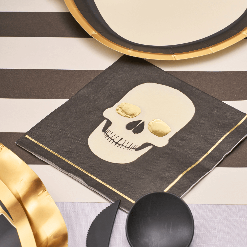 Classic Spooky Skull Cocktail Napkins set on a stylish black and gold table, perfect for enhancing Halloween-themed gatherings.