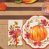 Autumn Foliage Guest Towel Napkins on a table, paired with a pumpkin-painted plate and glass, perfect for enhancing your party tablescape.