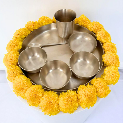 Brass Thali Set with bowls, a cup, and a spoon on a tray, ideal for gifting at festive gatherings, available at Party Social.