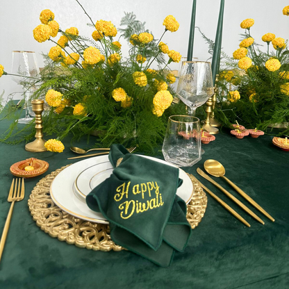 Printed Napkin (Diwali) - 4 per pack displayed on a table with a green cloth napkin and yellow flowers, enhancing festive tableware for elegant celebrations.