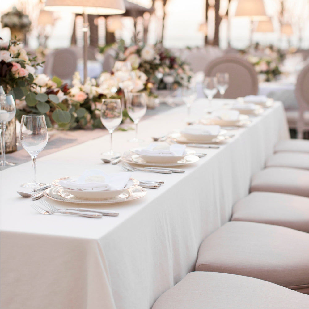 Rectangular tablecloth cotton linen adorning a long table set with wine glasses and tableware, ideal for special events and occasions.