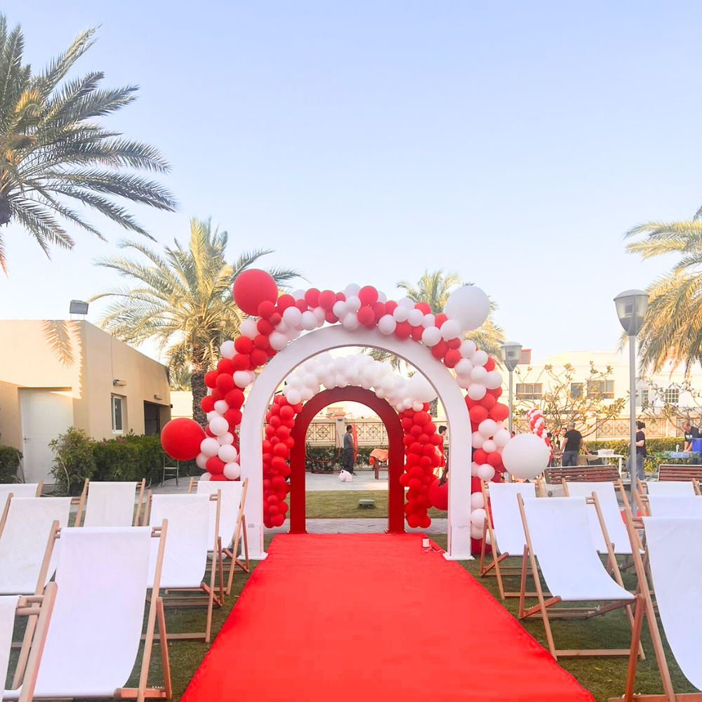 Wooden U-Shaped Backdrop on red carpet with white chairs, ideal for events like weddings or birthdays, available in customizable sizes.