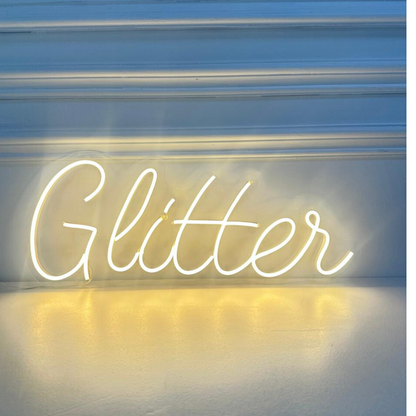 Glitter- LED Neon Sign creating a vibrant atmosphere, perfect for party backdrops or photo walls, available from Party Social.