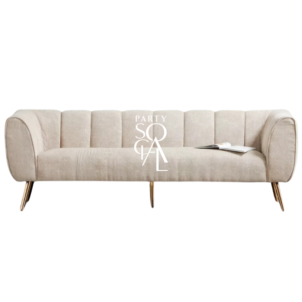 SAND TEXTURED SOFA 3-SEATER: A modern luxe white couch with a book, ideal for elegant lounge seating at events.