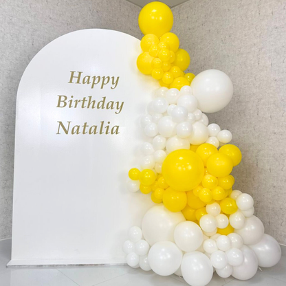 Simple Wood Curved Balloon Backdrop with white and yellow balloons, ideal for various events like birthdays or showers, customizable to fit your party theme.