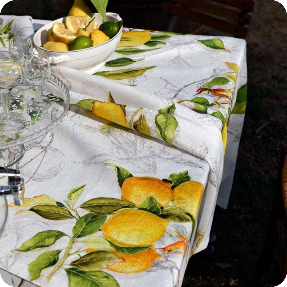 Limoncello Pure Linen Tablecloth on a table with a bowl of lemons and limes.