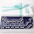 The Iftar Table Edit Gift Box: A white box with aqua ribbon, containing navy-and-white patterned napkins, ideal for Ramadan celebrations or gifting from Party Social.