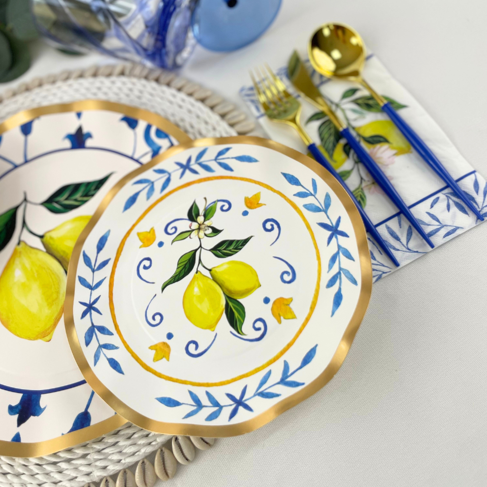 Capri Coast Paper Salad &amp; Dessert Plate featuring ruffled foil edge, intricate blue pattern, and lemons on white background. Adds elegance to events.