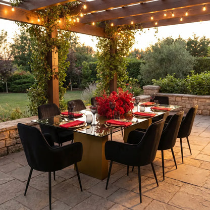 VELVET CHAIR BLACK adorned in a sophisticated outdoor dining setup beneath a pergola, highlighting its elegant pleated detailing, perfect for high-end entertaining.