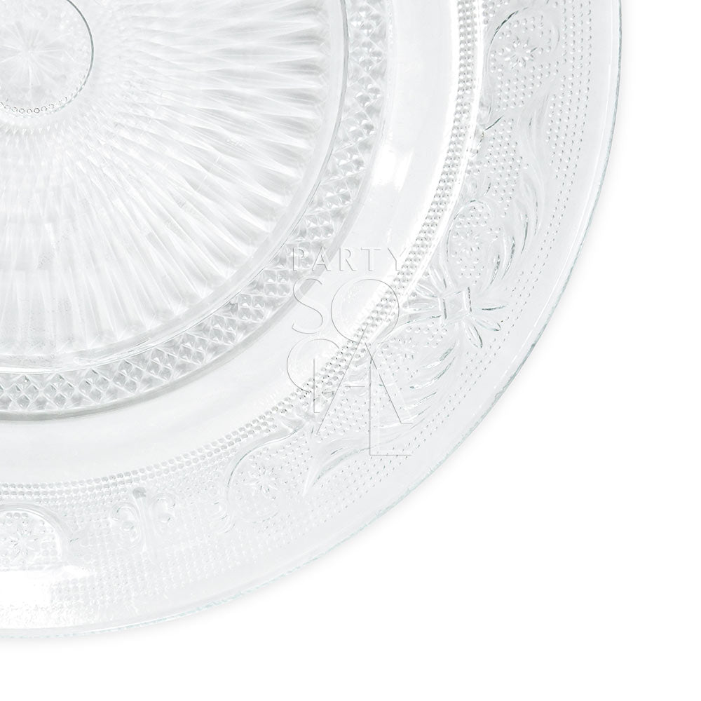Vintage clear glass plate, intricately etched, perfect for elegant table settings. Available in four sizes: charger, dinner, dessert, and B&amp;B. Ideal for special occasions.