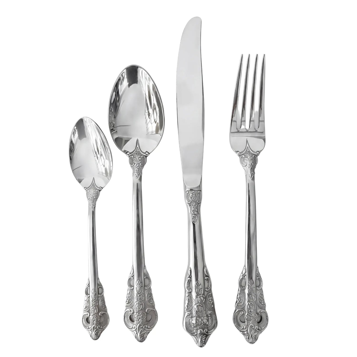 Vintage Silver Cutlery Collection: A set of four ornate silver-plated flatware pieces with scroll and floral patterns, including a teaspoon, tablespoon, dinner knife, and fork.